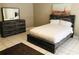 Modern bedroom with a queen size bed, dresser, mirror, and an artistic headboard at 240 W Lake Nw Dr, Atlanta, GA 30314