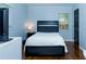 Comfortable bedroom featuring hardwood floors and natural light at 240 W Lake Nw Dr, Atlanta, GA 30314