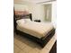 Bedroom features a queen size bed with gray wood accents and a modern design at 240 W Lake Nw Dr, Atlanta, GA 30314