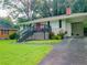 Single-story home with a brick chimney, carport, lush lawn, and inviting front entrance at 240 W Lake Nw Dr, Atlanta, GA 30314