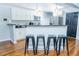 Well-lit kitchen with white cabinets, granite countertops, stainless steel appliances, and breakfast bar at 240 W Lake Nw Dr, Atlanta, GA 30314