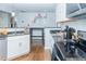 Bright kitchen features granite countertops, stainless steel appliances, and hardwood floors at 240 W Lake Nw Dr, Atlanta, GA 30314