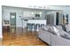 Modern open-concept kitchen with stainless steel appliances, white cabinets, and counter seating at 240 W Lake Nw Dr, Atlanta, GA 30314