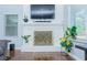Well-lit living room with a brick fireplace, hardwood floors, and modern decor at 240 W Lake Nw Dr, Atlanta, GA 30314
