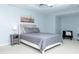 Comfortable main bedroom featuring light blue walls, a tray ceiling, and contemporary decor at 240 W Lake Nw Dr, Atlanta, GA 30314