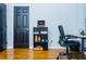 Home office space with desk, chair, modern shelving, and hardwood flooring at 240 W Lake Nw Dr, Atlanta, GA 30314