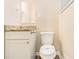 Cozy bathroom featuring a granite countertop, classic vanity, and white toilet at 3656 Tulip Dr, Decatur, GA 30032