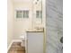 Beautiful bathroom features a granite vanity, tile accents and natural light from the window at 3656 Tulip Dr, Decatur, GA 30032