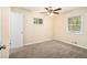 A bright bedroom with carpet flooring, a ceiling fan, and two windows at 3656 Tulip Dr, Decatur, GA 30032