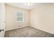 Cozy bedroom with neutral carpeting and a window offering natural light at 3656 Tulip Dr, Decatur, GA 30032