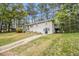 Split-level home with a white exterior, and a staircase leading to a backyard deck at 3656 Tulip Dr, Decatur, GA 30032