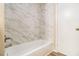 Elegant shower featuring large marble-style tile and a modern shower head at 3656 Tulip Dr, Decatur, GA 30032