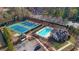 Aerial view showcasing tennis courts, pool, and clubhouse, offering recreational amenities for residents at 3740 Williams Point Dr, Cumming, GA 30028