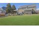 Wide shot of a spacious lawn and backyard with outdoor living spaces and patio at 3740 Williams Point Dr, Cumming, GA 30028