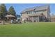 Expansive backyard with a well-maintained lawn and multiple seating and dining areas at 3740 Williams Point Dr, Cumming, GA 30028