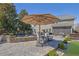 Beautiful backyard patio with an umbrella, a seating area, and water feature, perfect for outdoor relaxation at 3740 Williams Point Dr, Cumming, GA 30028