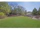 Large backyard with manicured lawn, mature trees, outdoor seating and patio area at 3740 Williams Point Dr, Cumming, GA 30028