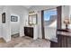 Elegant bathroom with a dark vanity, a large mirror, stylish fixtures, and marble style tile flooring at 3740 Williams Point Dr, Cumming, GA 30028