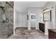 Bathroom featuring a marble-walled shower, double doors and a dark wood cabinet at 3740 Williams Point Dr, Cumming, GA 30028