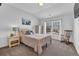 Cozy bedroom features a queen-sized bed, rocking chair, and ample natural light from the window at 3740 Williams Point Dr, Cumming, GA 30028
