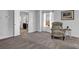 Cozy bedroom with neutral carpet, a comfortable chair, and an ensuite bathroom beyond double doors at 3740 Williams Point Dr, Cumming, GA 30028