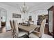 Formal dining room with dark wood floors, chandelier, and adjacent sitting room at 3740 Williams Point Dr, Cumming, GA 30028