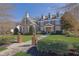 Charming home with a manicured lawn, beautiful landscaping, and detailed architectural design at 3740 Williams Point Dr, Cumming, GA 30028