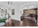 Bright entryway with dark wood floors, staircase, and view of the music room at 3740 Williams Point Dr, Cumming, GA 30028