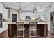 Well-lit kitchen featuring a center island, breakfast bar, and modern appliances at 3740 Williams Point Dr, Cumming, GA 30028