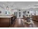 Open-concept kitchen and dining area featuring a spacious island, modern appliances, and hardwood floors at 3740 Williams Point Dr, Cumming, GA 30028