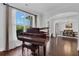 Living room features hardwood floors, piano and expansive window at 3740 Williams Point Dr, Cumming, GA 30028