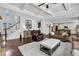 Open-concept living space with staircase, hardwood floors, and abundant natural light at 3740 Williams Point Dr, Cumming, GA 30028