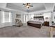 Serene main bedroom with a tray ceiling, plush carpet, and a comfortable seating area at 3740 Williams Point Dr, Cumming, GA 30028