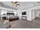 Relaxing main bedroom featuring tray ceilings, plush carpet, ceiling fan and an adjoining door at 3740 Williams Point Dr, Cumming, GA 30028