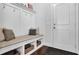 Bright mudroom with white wainscoting, built-in bench with storage, and convenient coat hooks at 3740 Williams Point Dr, Cumming, GA 30028