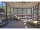 Inviting screened-in porch with a hanging swing chair, comfortable seating, and views of backyard at 3740 Williams Point Dr, Cumming, GA 30028