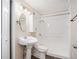 A clean bathroom with a pedestal sink and shower/tub combination at 10164 Sunny Sw Dr, Covington, GA 30014