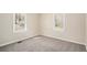 Bright bedroom with neutral walls, plush carpeting, and two windows that flood the room with light at 10164 Sunny Sw Dr, Covington, GA 30014