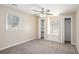 Cozy bedroom with fan, carpet, closet space, and a built-in cabinet underneath the window at 10164 Sunny Sw Dr, Covington, GA 30014