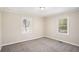 Cozy bedroom with neutral walls, plush carpeting, and two windows that flood the room with light at 10164 Sunny Sw Dr, Covington, GA 30014