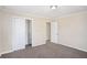 Inviting bedroom features neutral walls, plush carpeting, and ample closet space for storage solutions at 10164 Sunny Sw Dr, Covington, GA 30014