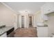 Kitchen features white cabinets and granite countertops, seamlessly connecting to other living areas at 10164 Sunny Sw Dr, Covington, GA 30014