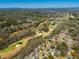 Expansive aerial view of a golf course community, featuring lush greenery and well-maintained homes at 2025 Fairway Crossing Dr, Woodstock, GA 30188