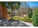 Large backyard with lush green grass, mature trees and tiered landscaping creating a peaceful outdoor space at 2025 Fairway Crossing Dr, Woodstock, GA 30188