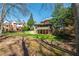 Green backyard showcasing the house's rear exterior, along with a lower-level covered area and upper-level deck at 2025 Fairway Crossing Dr, Woodstock, GA 30188