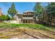 Lush backyard with mature trees, a screened-in porch, and ample space for outdoor activities at 2025 Fairway Crossing Dr, Woodstock, GA 30188