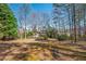 Expansive backyard with mature trees providing shade and privacy, offering ample space for outdoor activities at 2025 Fairway Crossing Dr, Woodstock, GA 30188