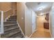Carpeted stairs lead to a finished basement with a kitchenette area, perfect for entertaining or relaxation at 2025 Fairway Crossing Dr, Woodstock, GA 30188