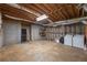 Unfinished basement with exposed beams, concrete walls, and laundry area at 2025 Fairway Crossing Dr, Woodstock, GA 30188