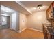 A convenient kitchenette with wooden cabinets and a stylish backsplash enhances this finished basement area at 2025 Fairway Crossing Dr, Woodstock, GA 30188